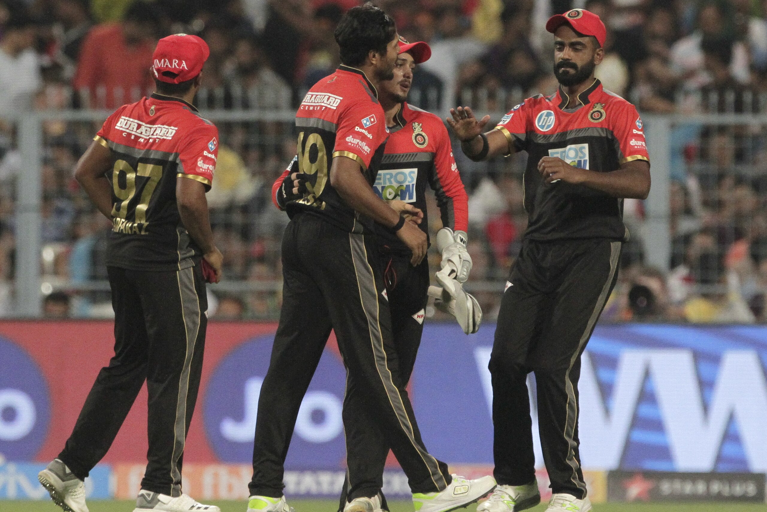 Royal Challengers Bangalore's teammates congratulate Umesh Yadav as he dismissed Kolkata Knight Riders' Sunil Narine during VIVO IPL cricket T20 match in Kolkata, India, Sunday, April 8, 2018. (AP Photo/Bikas Das)