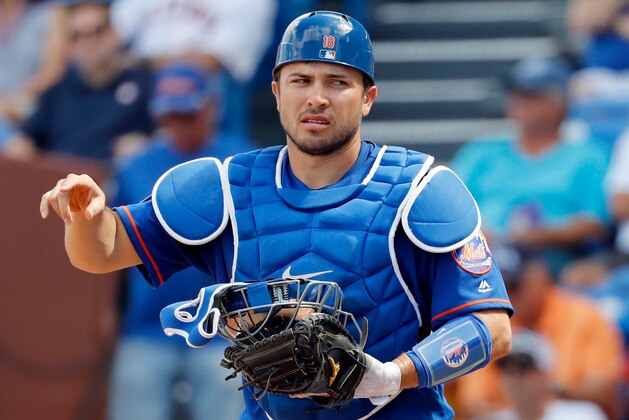 FILE - In this Feb. 27, 2018, file photo, New York Mets catcher Travis d'Arnaud is seen during the second inning of an exhibition spring training baseball game against the Houston Astros, in Port St. Lucie, Fla. d'Arnaud is on the disabled list for the fifth straight year, and the injury appears to be significant. New York said Wednesday, April 11, 2018, that d'Arnaud has a partial tear of the ulnar collateral ligament in his right elbow. (AP Photo/Jeff Roberson, File)