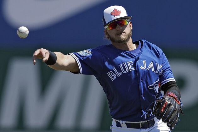 Toronto Blue Jays third baseman Josh Donaldson (20) throws out Philadelphia Phillies' Ryan Flaherty at first during the second inning of a spring training baseball game Wednesday, March 21, 2018, in Dunedin, Fla. (AP Photo/Chris O'Meara)