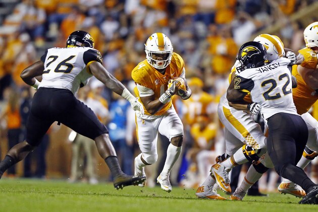 Tennessee running back John Kelly (4) runs for yardage as he's defended by Southern Mississippi linebacker Jeremy Sangster (26) in the first half of an NCAA college football game Saturday, Nov. 4, 2017, in Knoxville, Tenn. (AP Photo/Wade Payne)