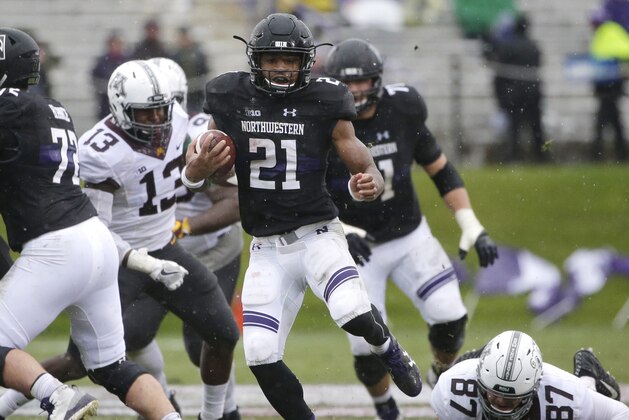Northwestern running back Justin Jackson (21) runs with the ball against Minnesota during the first half of an NCAA college football game in Evanston, Ill., Saturday, Nov. 18, 2017. (AP Photo/Nam Y. Huh)