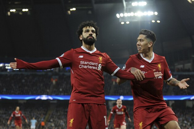 Liverpool's Mohamed Salah, left, celebrates scoring his side's first goal with Liverpool's Roberto Firmino during the Champions League quarterfinal second leg soccer match between Manchester City and Liverpool at Etihad stadium in Manchester, England, Tuesday, April 10, 2018. (AP Photo/Rui Vieira)
