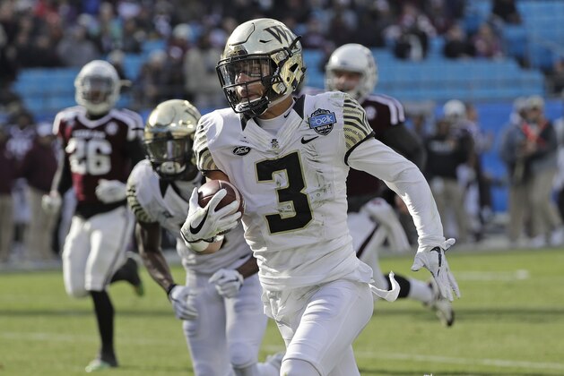 Wake Forest's Jessie Bates III (3) returns a punt for a touchdown against Texas A&M during the first half of the Belk Bowl NCAA college football game in Charlotte, N.C., Friday, Dec. 29, 2017. (AP Photo/Chuck Burton)