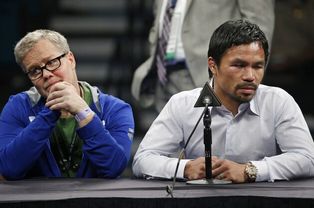 Trainer Freddie Roach, left, listens as Manny Pacquiao answers reporter questions during a press conference following his welterweight title fight on Saturday, May 2, 2015 in Las Vegas. Floyd Mayweather defeated Pacquiao in a unanimous decision. (AP Photo/John Locher)