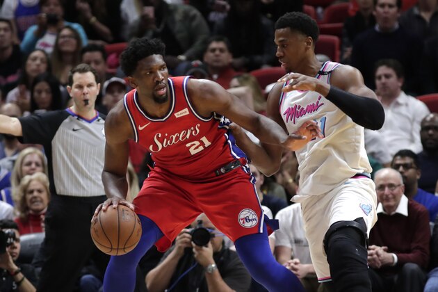 Philadelphia 76ers' Joel Embiid, left drives past Miami Heat center Hassan Whiteside (21) during the second half of an NBA basketball game, Thursday, March 8, 2018, in Miami. The Heat won 108-99. (AP Photo/Lynne Sladky)