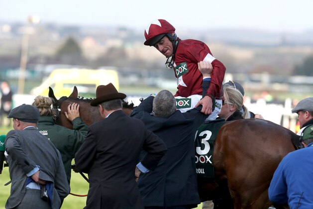 Jockey Davy Russell is congratulated by trainer Gordon Elliott (C) after riding Tiger Roll to victory in the Grand National horse race on the final day of the Grand National Festival at Aintree Racecourse in Liverpool, northern England on April 14, 2018.  / AFP PHOTO / Jason ROBERTS        (Photo credit should read JASON ROBERTS/AFP/Getty Images)
