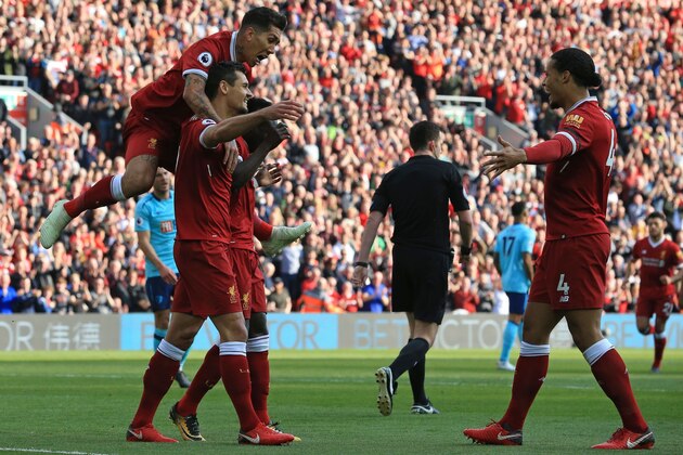 Liverpool's Senegalese midfielder Sadio Mane (3rd L) celebrates with teammates after scoring the opening goal of the English Premier League football match between Liverpool and Bournemouth at Anfield in Liverpool, north west England on April 14, 2018. / AFP PHOTO / Lindsey PARNABY / RESTRICTED TO EDITORIAL USE. No use with unauthorized audio, video, data, fixture lists, club/league logos or 'live' services. Online in-match use limited to 75 images, no video emulation. No use in betting, games or single club/league/player publications.  /         (Photo credit should read LINDSEY PARNABY/AFP/Getty Images)