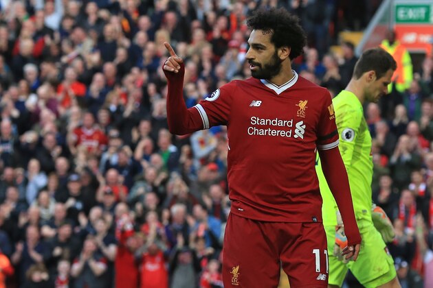Liverpool's Egyptian midfielder Mohamed Salah celebrates after scoring their second goal during the English Premier League football match between Liverpool and Bournemouth at Anfield in Liverpool, north west England on April 14, 2018. / AFP PHOTO / Lindsey PARNABY / RESTRICTED TO EDITORIAL USE. No use with unauthorized audio, video, data, fixture lists, club/league logos or 'live' services. Online in-match use limited to 75 images, no video emulation. No use in betting, games or single club/league/player publications.  /         (Photo credit should read LINDSEY PARNABY/AFP/Getty Images)