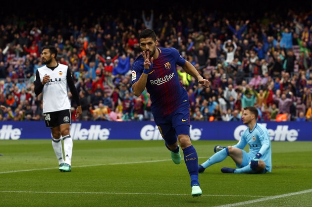 FC Barcelona's Luis Suarez celebrates after scoring during the Spanish La Liga soccer match between FC Barcelona and Valencia at the Camp Nou stadium in Barcelona, Spain, Saturday, April 14, 2018. (AP Photo/Manu Fernandez)