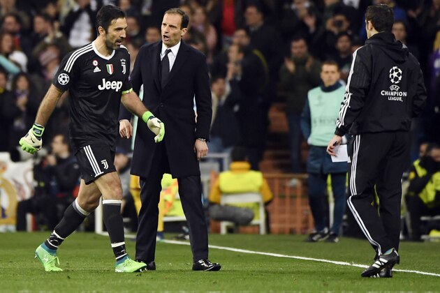 Juventus' Italian coach Massimiliano Allegri (R) talks to Juventus' Italian goalkeeper Gianluigi Buffon as he leaves the field after being shown a red card during the UEFA Champions League quarter-final second leg football match between Real Madrid CF and Juventus FC at the Santiago Bernabeu stadium in Madrid on April 11, 2018. / AFP PHOTO / PIERRE-PHILIPPE MARCOU        (Photo credit should read PIERRE-PHILIPPE MARCOU/AFP/Getty Images)
