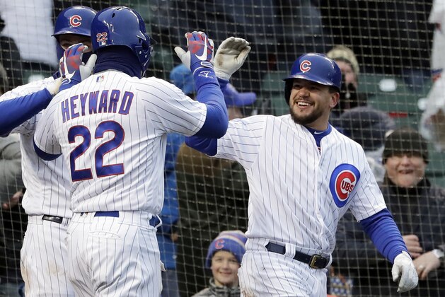 Chicago Cubs' Kyle Schwarber, right, celebrates with Jason Heyward (22) after they scoring on a wild pitch by Atlanta Braves relief pitcher Peter Moylan during the eighth inning of a baseball game Saturday, April 14, 2018, in Chicago. (AP Photo/Nam Y. Huh)