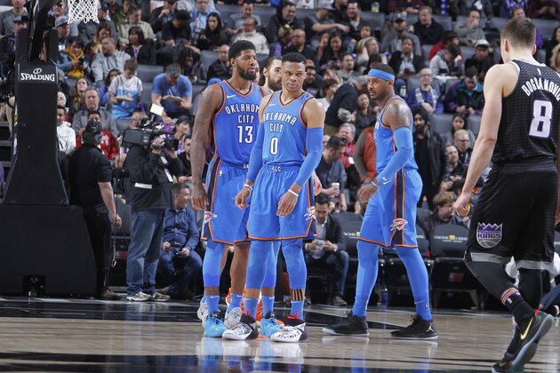 SACRAMENTO, CA - FEBRUARY 22: Paul George #13, Russell Westbrook #0 and Carmelo Anthony #7 of the Oklahoma City Thunder face the Sacramento Kings on February 22, 2018 at Golden 1 Center in Sacramento, California. NOTE TO USER: User expressly acknowledges and agrees that, by downloading and or using this photograph, User is consenting to the terms and conditions of the Getty Images Agreement. Mandatory Copyright Notice: Copyright 2018 NBAE (Photo by Rocky Widner/NBAE via Getty Images)