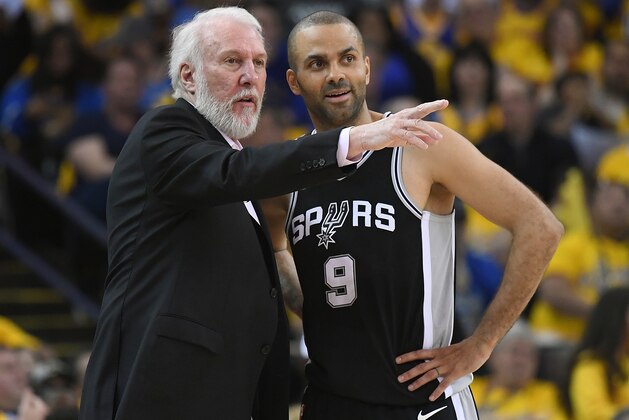 OAKLAND, CA - APRIL 14:  Head coach Gregg Popovich of the San Antonio Spurs talks with his player Tony Parker #9 against the Golden State Warriors in the second quarter during Game One of the first round of the 2018 NBA Playoff at ORACLE Arena on April 14, 2018 in Oakland, California. NOTE TO USER: User expressly acknowledges and agrees that, by downloading and or using this photograph, User is consenting to the terms and conditions of the Getty Images License Agreement.  (Photo by Thearon W. Henderson/Getty Images)
