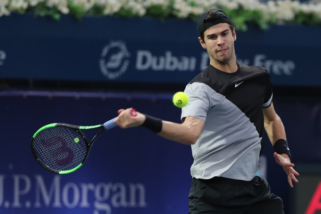 Russia's Karen Khachanov returns the ball to Lucas Pouille of France (unseen) during their Dubai Duty Free Tennis singles match on February 28, 2018. / AFP PHOTO / KARIM SAHIB        (Photo credit should read KARIM SAHIB/AFP/Getty Images)