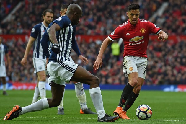 Manchester United's Chilean striker Alexis Sanchez (R) vies with West Bromwich Albion's French-born Cameroonian defender Allan Nyom during the English Premier League football match between Manchester United and West Bomwich Albion at Old Trafford in Manchester, north west England, on April 15, 2018. / AFP PHOTO / PAUL ELLIS / RESTRICTED TO EDITORIAL USE. No use with unauthorized audio, video, data, fixture lists, club/league logos or 'live' services. Online in-match use limited to 75 images, no video emulation. No use in betting, games or single club/league/player publications.  /         (Photo credit should read PAUL ELLIS/AFP/Getty Images)