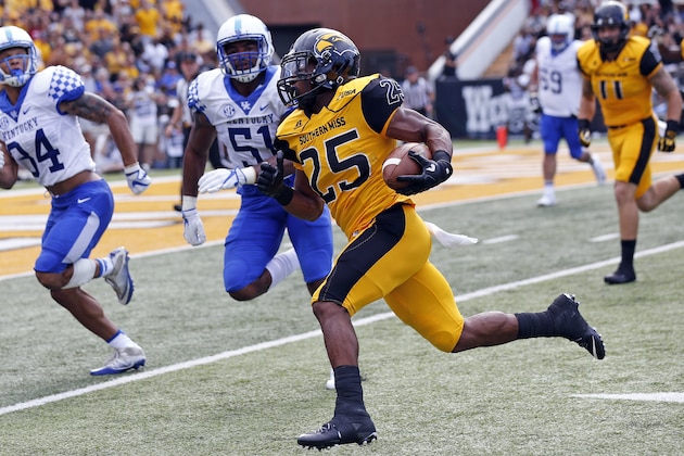 Southern Mississippi running back Ito Smith (25) runs upfield past Kentucky defenders for a first down during the first half of an NCAA college football game in Hattiesburg, Miss., Saturday, Sept. 2, 2017. (AP Photo/Rogelio V. Solis)