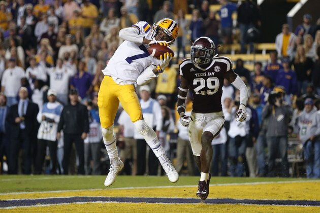 LSU wide receiver D.J. Chark (7) pulls in a touchdown reception in front of Texas A&M defensive back Debione Renfro (29) in the second half of an NCAA college football game in Baton Rouge, La., Saturday, Nov. 25, 2017. LSU won 45-21. (AP Photo/Gerald Herbert)