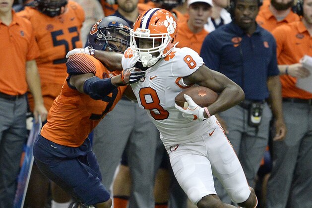 Clemson wide receiver Deon Cain (8) tries to break free of Syracuse defensive back Juwan Dowels (9) after making a catch during the second half of an NCAA college football game, Friday, Oct. 13, 2017, in Syracuse, N.Y. Syracuse upset No. 2 Clemson 27-24. (AP Photo/Adrian Kraus)