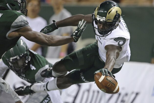 FILE - This Sept. 30, 2017, file photo shows Hawaii defensive backs Trayvon Henderson (39) and Daniel Lewis Jr. (4), defending Colorado State wide receiver Michael Gallup (4) who tries to leap into the end zone during the second quarter of the NCAA college football in Honolulu. Colorado State and Marshall, two programs that started strong only to end finish slow this season, are meeting in the New Mexico Bowl to help kick off the college postseason. (AP Photo/Marco Garcia, File)