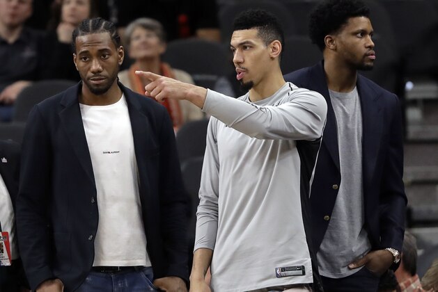San Antonio Spurs guard Danny Green, center, stands at the bench with injured teammates Kawhi Leonard, left, and Rudy Gay, right, during the second half of an NBA basketball game against the Indiana Pacers, Sunday, Jan. 21, 2018, in San Antonio. Indiana won 94-86. (AP Photo/Eric Gay) San Antonio Spurs guard Danny Green, center, stands at the bench with injured teammates Kawhi Leonard, left, and Rudy Gay, right, during the second half of an NBA basketball game against the Indiana Pacers, Sunday, Jan. 21, 2018, in San Antonio. Indiana won 94-86. (AP Photo/Eric Gay)
