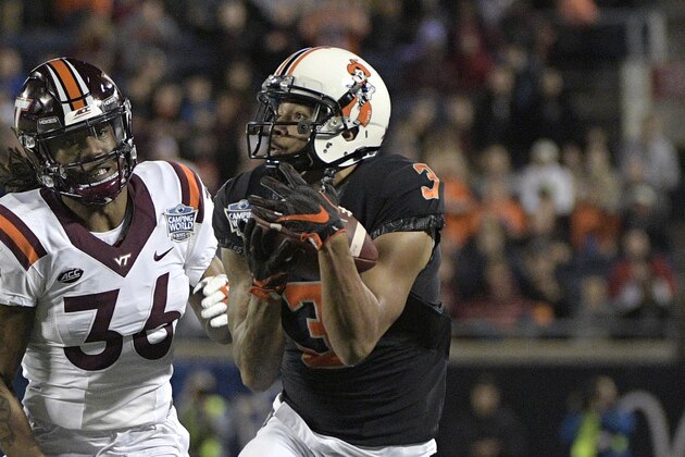 Oklahoma State wide receiver Marcell Ateman (3) runs after catching a pass in front of Virginia Tech cornerback Adonis Alexander (36) during the first half of the Camping World Bowl NCAA college football game Thursday, Dec. 28, 2017, in Orlando, Fla. (AP Photo/Phelan M. Ebenhack)