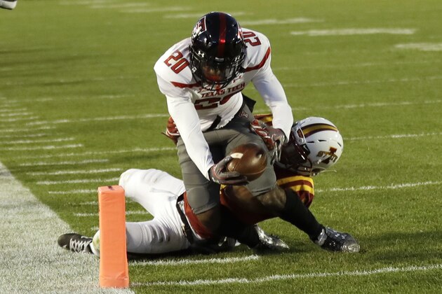 Texas Tech wide receiver Keke Coutee (20) dives over Iowa State defensive back Evrett Edwards while scoring on an 11-yard touchdown reception during the second half of an NCAA college football game, Saturday, Nov. 19, 2016, in Ames, Iowa. Iowa State won 66-10. (AP Photo/Charlie Neibergall)