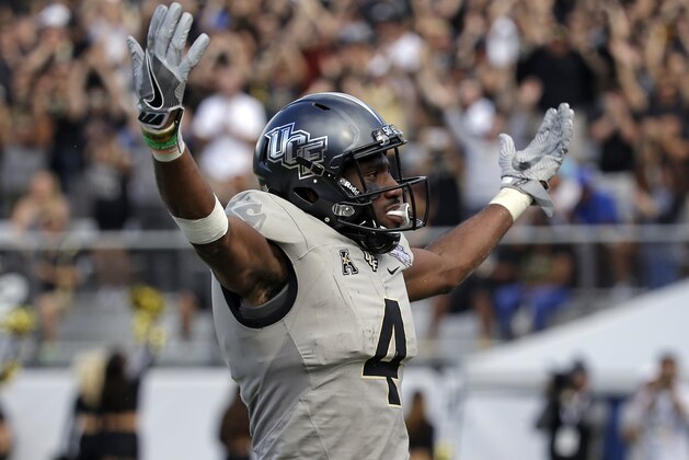 Central Florida wide receiver Tre'Quan Smith (4) celebrates with fans after scoring a touchdown against Memphis during the second half of the American Athletic Conference championship NCAA college football game, Saturday, Dec. 2, 2017, in Orlando, Fla. Central Florida won in overtime 62-55. (AP Photo/John Raoux)