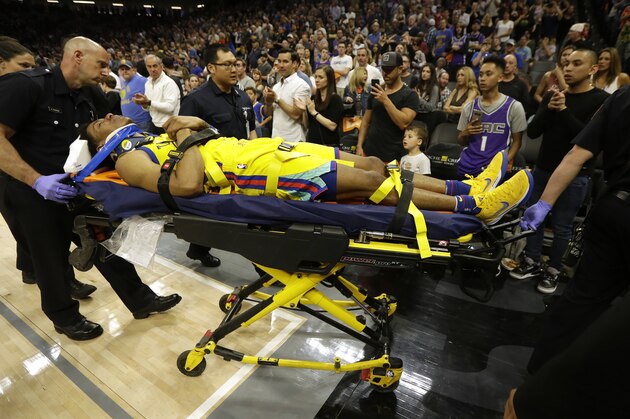 Golden State Warriors guard Patrick McCaw is taken off the court on a stretcher after falling hard to the floor late in the third quarter following a Flagrant 1 foul by Sacramento Kings's Vince Carter in an NBA basketball game Saturday, March 31, 2018, in Sacramento, Calif. The Warriors won 112-96. (AP Photo/Rich Pedroncelli)