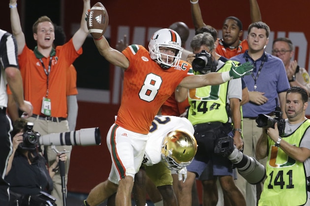 Miami wide receiver Braxton Berrios (8) celebrates after scoring a touchdown during the first half of an NCAA college football game against Notre Dame, Saturday, Nov. 11, 2017, in Miami Gardens, Fla. (AP Photo/Lynne Sladky)