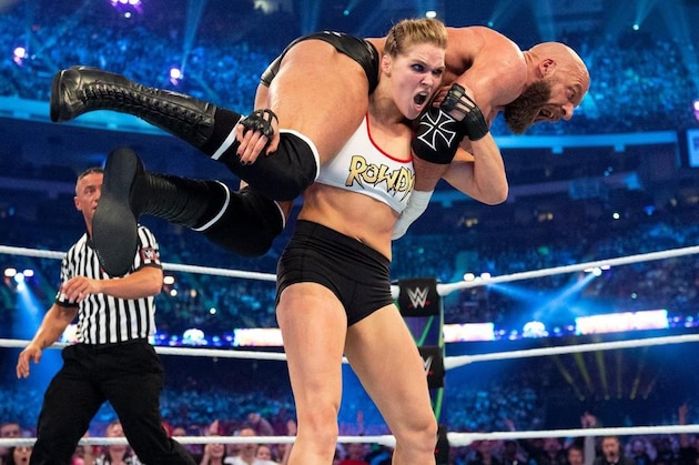 Ronda Rousey slams Triple H at WrestleMania 34.
