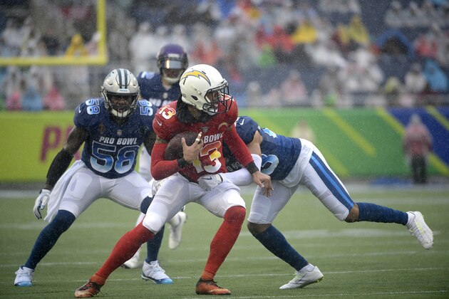 AFC receiver Keenan Allen (13), of the Los Angeles Chargers, catches a pass in front of NFC linebacker Thomas Davis (58), of the Carolina Panthers, and defensive back Marshon Lattimore, right, of the New Orleans Saints, during the first half of NFL Pro Bowl football game Sunday, Jan. 28, 2018, in Orlando, Fla. The AFC won 24-23. (AP Photo/Phelan M. Ebenhack)