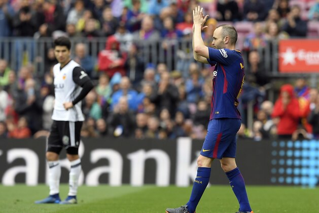 Barcelona's Spanish midfielder Andres Iniesta applauds as he leaves the pitch during the Spanish league footbal match between FC Barcelona and Valencia CF at the Camp Nou stadium in Barcelona on April 14, 2018. / AFP PHOTO / LLUIS GENE        (Photo credit should read LLUIS GENE/AFP/Getty Images)