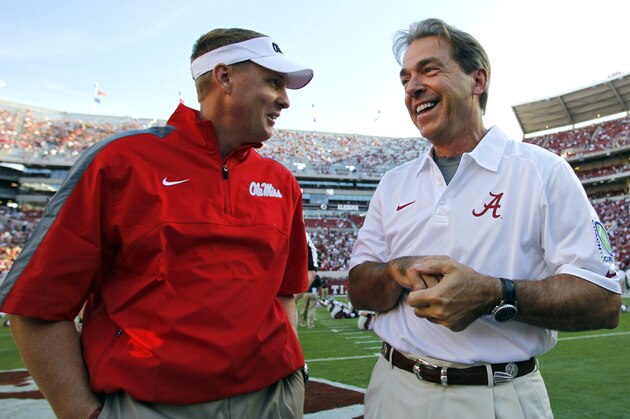 FILE - In this Sept. 28, 2013, file photo, Alabama head coach Nick Saban talks with Mississippi head coach Hugh Freeze before an NCAA college football game in Tuscaloosa, Ala. The 15th-ranked Rebels and No. 2 Alabama take center stage in Tuscaloosa on Saturday night for a game with no shortage of story lines. (AP Photo/Butch Dill, File)