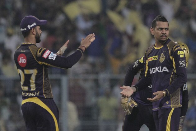 Kolkata Night Riders' teammate congratulates Sunil Narine, right for taking Delhi Daredevils' Chris Morris during VIVO IPL cricket T20 match in Kolkata, India, Monday, April 16, 2018. (AP Photo/Bikas Das)
