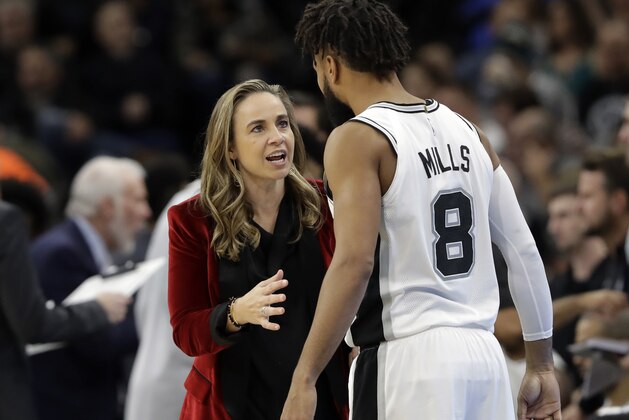 San Antonio Spurs assistant coach Becky Hammon, left, talks with guard Patty Mills (8) during the second half of an NBA basketball game against the New York Nets, Tuesday, Dec. 26, 2017, in San Antonio. San Antonio won 109-97.(AP Photo/Eric Gay)