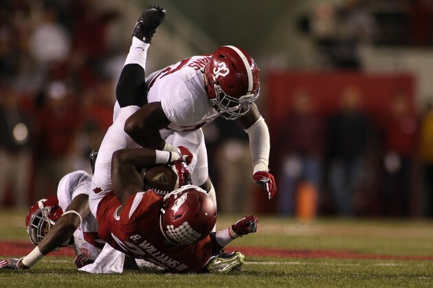 Arkansas'  Rawleigh Williams III (22) is tackled by Alabama's Rashaan Evans (32) during the second half of an NCAA college football game Saturday, Oct. 8, 2016 in Fayetteville, Ark. Alabama beat Arkansas 49-30. (AP Photo/Samantha Baker)
