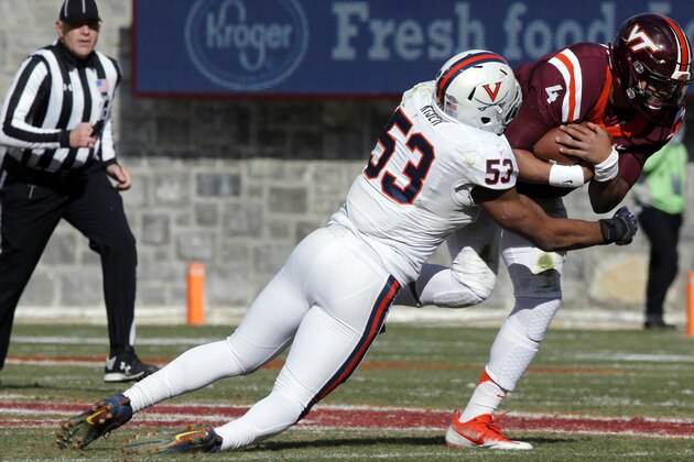 FILE - In this Nov. 26, 2016, file photo, Virginia linebacker Micah Kiser (53) wraps up Virginia Tech quarterback Jerod Evans (4) during the first half of an NCAA college football game in Blacksburg, Va. Kiser was selected to the 2017 AP All-Conference ACC team announced Tuesday, Dec. 5, 2017. (AP Photo/Steve Helber, File)