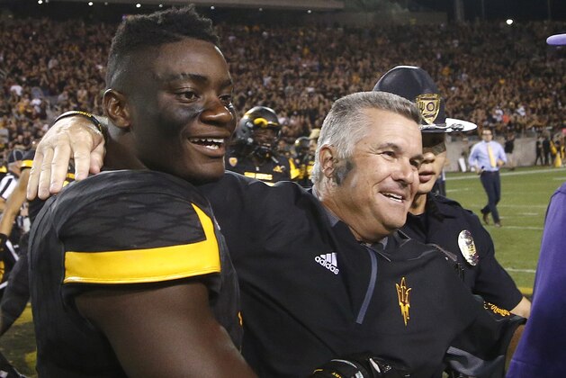FILE - In this Oct. 14, 2017, file photo, Arizona State head coach Todd Graham, right, celebrates with linebacker Christian Sam, left, after an NCAA college football game against Washington in Tempe, Ariz. The Sun Devils are 5-5 overall and 4-3 in the Pac-12 with two games to go. The first chance to reach six wins is against Oregon State on Saturday, Nov. 18, 2017, in Corvallis, Ore. (AP Photo/Ross D. Franklin, File)