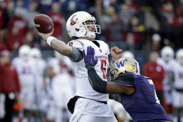 Washington State quarterback Peyton Bender (6) is rushed by Washington's Keishawn Bierria in the first half of an NCAA college football game Friday, Nov. 27, 2015, in Seattle. (AP Photo/Elaine Thompson)