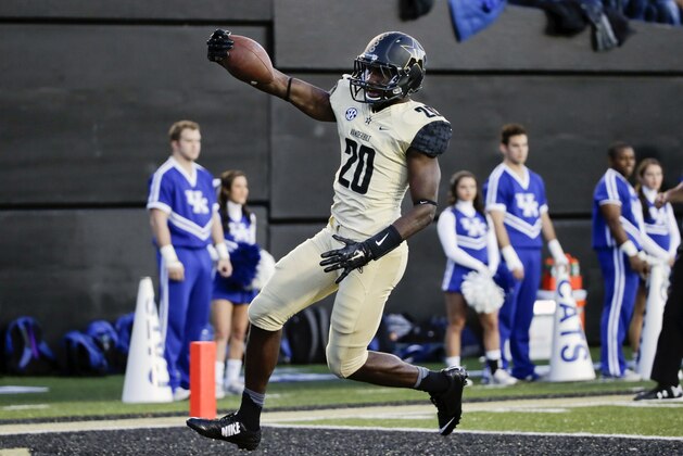 Vanderbilt safety Oren Burks (20) returns a pass interception 30 yards for a touchdown against Kentucky in the first half of an NCAA college football game Saturday, Nov. 14, 2015, in Nashville, Tenn. (AP Photo/Mark Humphrey)