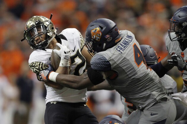 Syracuse's Zaire Franklin, right, tries to take down Wake Forest's Matt Colburn II, left, the second half of an NCAA college football game in Syracuse, N.Y., Saturday, Nov. 11, 2017. (AP Photo/Nick Lisi)