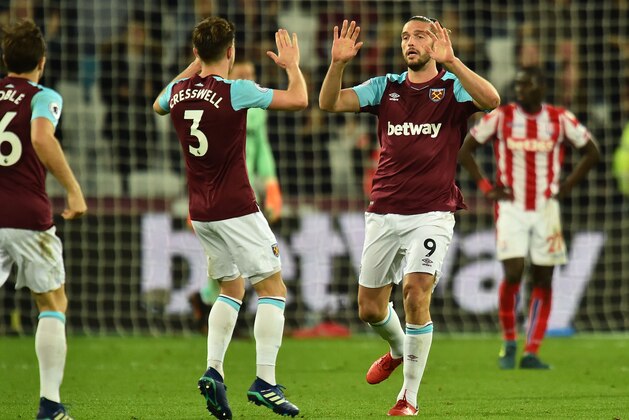 West Ham United's English striker Andy Carroll (R) celebrates scoring his team's first goal with West Ham United's English defender Aaron Cresswell during the English Premier League football match between West Ham United and Stoke City at The London Stadium, in east London on April 16, 2018. / AFP PHOTO / Glyn KIRK / RESTRICTED TO EDITORIAL USE. No use with unauthorized audio, video, data, fixture lists, club/league logos or 'live' services. Online in-match use limited to 75 images, no video emulation. No use in betting, games or single club/league/player publications.  /         (Photo credit should read GLYN KIRK/AFP/Getty Images)