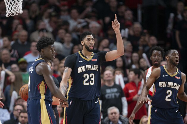 New Orleans Pelicans guard Jrue Holiday, forward Anthony Davis and guard Ian Clark celebrate a score against the Portland Trail Blazers during the second half in Game 1 of an NBA basketball first-round playoff series Saturday, April 14, 2018, in Portland, Ore. New Orleans won 97-95. (AP Photo/Randy L. Rasmussen)