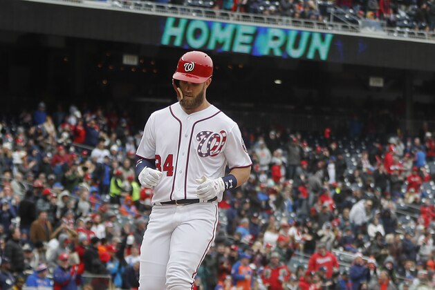 Washington Nationals' Bryce Harper (34) touches home after hitting a solo home run off New York Mets relief pitcher Hansel Robles during the sixth inning of baseball game at Nationals Park, Saturday, April 7, 2018 in Washington. (AP Photo/Pablo Martinez Monsivais)