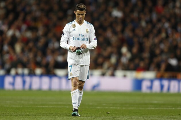 Real Madrid's Cristiano Ronaldo hols his shoe during a Champions League quarter final second leg soccer match between Real Madrid and Juventus at the Santiago Bernabeu stadium in Madrid, Wednesday, April 11, 2018. (AP Photo/Francisco Seco)