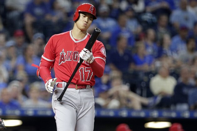 Los Angeles Angels' Shohei Ohtani looks at his bat while hitting during the seventh inning of a baseball game against the Kansas City Royals Thursday, April 12, 2018, in Kansas City, Mo. (AP Photo/Charlie Riedel)