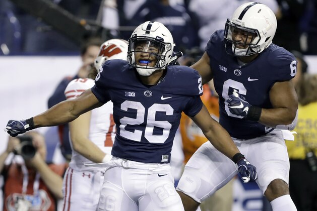 FILE - In this Saturday, Dec. 3, 2016, file photo, Penn State's Saquon Barkley (26) is congratulated by teammate Andre Robinson after catching an 18-yard pass for a touchdown during the second half of the Big Ten championship NCAA college football game against Wisconsin, in Indianapolis. A case can be made that Penn State’s Barkley is both the best and strongest running back in college football. Coming off a sophomore season in which he ran for 1,496 yards and scored 22 touchdowns, Barkley was overwhelmingly selected to the AP’s preseason All-America team. (AP Photo/Michael Conroy, File)
