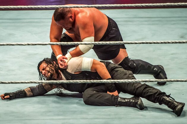 Roman and Samoa Joe (R) battle during the WWE show at Zenith Arena on may 09, 2017 in Lille, France. / AFP PHOTO / PHILIPPE HUGUEN        (Photo credit should read PHILIPPE HUGUEN/AFP/Getty Images)