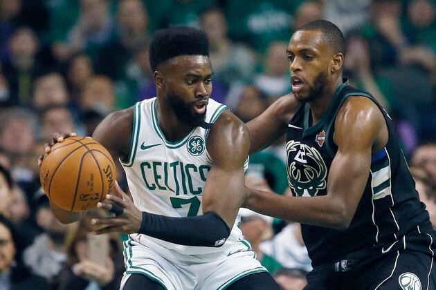 Boston Celtics' Jaylen Brown (7) looks to move against Milwaukee Bucks' Khris Middleton (22) during the first quarter of Game 1 of an NBA basketball first-round playoff series, in Boston, Sunday, April 15, 2018. (AP Photo/Michael Dwyer)