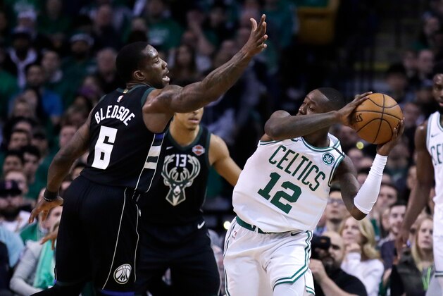Milwaukee Bucks guard Eric Bledsoe, left, pressures Boston Celtics guard Terry Rozier, right, during the first quarter of Game 2 of an NBA basketball first-round playoff series in Boston, Tuesday, April 17, 2018. (AP Photo/Charles Krupa)